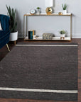 Violet Artistic Brown Flatweave Wool Rug, its textured wool fibers swirling in earthy browns and violets, lending warmth and artistic flair to a contemporary living space.