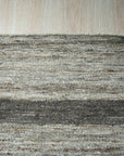 Lila Violet Light Gray Flatweave Wool Rug in situ; light-filled room showcases its subtle violet and light gray hues complementing modern furniture and light wood floors. Flatweave construction provides a low pile and textural interest.