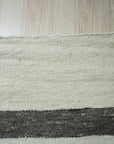 Artisan Nadia Ivory Flatweave Wool Rug, lending warmth to a light-filled living room, features a subtle geometric pattern woven in soft ivory wool. Flatweave construction offers a low profile and durable surface.