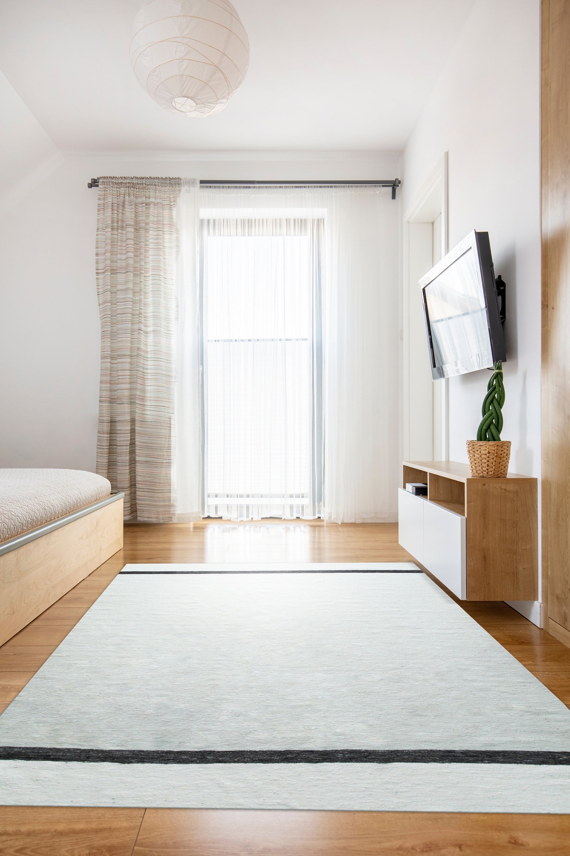 Artisan Nadia Ivory Flatweave Wool Rug, its subtle ivory tones and flatweave construction lending a calming presence to a bright, modern living space.