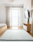 Artisan Nadia Ivory Flatweave Wool Rug, its subtle ivory tones and flatweave construction lending a calming presence to a bright, modern living space.