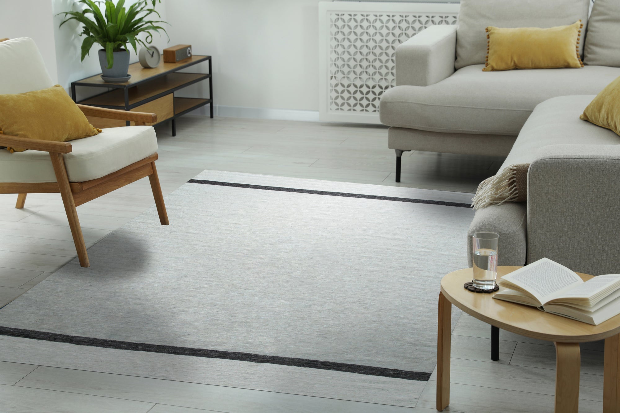 Artisan Nadia Ivory Flatweave Wool Rug, soft ivory tones and subtle texture enhance a bright, airy living room with minimalist décor. Woven wool adds warmth and sophistication.