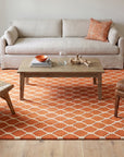 Amara Delicate Orange Hand Tufted Wool Rug in a living room