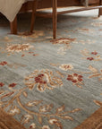 Amara Elegant Gray and Gold Machine Made Wool Rug in a bedroom