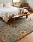 Amara Elegant Gray and Gold Machine Made Wool Rug in a bedroom