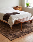 Artistic Brown Hand Knotted Wool Rug in a bedroom