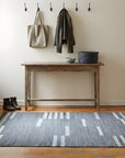 Cassandra Clara Gray and Ivory Flatweave Wool Rug in a entryway
