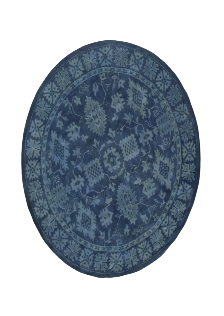 Rustic Oriental Blue Hand Tufted Wool Rug, displaying a vibrant blue palette and intricate oriental motifs, laid in a bright living room setting. Hand-tufted wool construction offers a textured feel.