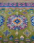 Green and fuchsia Kazak rug top-down three-medallion detail