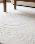Handcrafted Artisan Ivory Hand Tufted Wool Rug in a living room