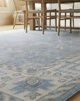 Harlow Traditional Blue and Gray Hand Knotted Wool Rug in a dining room