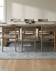 Harlow Traditional Blue and Gray Hand Knotted Wool Rug in a dining room