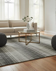 Gray contemporary geometric loom-check wool and viscose area rug styled in a living room