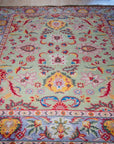 Light green Oushak floral wool rug, angled full view