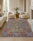 Light green Oushak floral rug styled in a living room