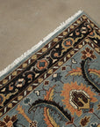 Gray and navy traditional hand-knotted wool rug KR110GY shown in a styled interior setting