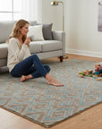 Gray transitional trellis handmade wool and viscose area rug styled in a living room