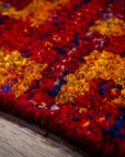 Sari-silk red abstract Anand rug edge and pile texture close-up