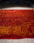 Hand-knotted sari-silk red abstract Anand rug, full view on the floor