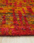 Anand red sari-silk rug corner detail showing abstract gold and orange pattern