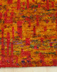 Close-up of Anand rug recycled sari-silk pile texture in red and gold