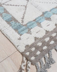 Timeless Marrakech Ivory Hand-Knotted Wool Rug, warm living room scene highlighting the rug’s texture and subtle ivory tones under soft natural light.
