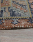 Luna Kilim Blue Hand Knotted Wool Rug, vibrant blues and geometric patterns grounding a light-filled living space, its hand-knotted texture adding warmth and subtle detail.