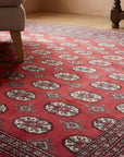 Rustic Nina Red Hand Knotted Wool Rug in a reading nook