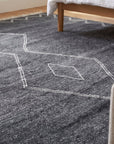 Talia Moroccan Charcoal Hand Knotted Wool Rug in a bedroom