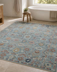 Turquoise Oushak floral rug styled in a spa bathroom