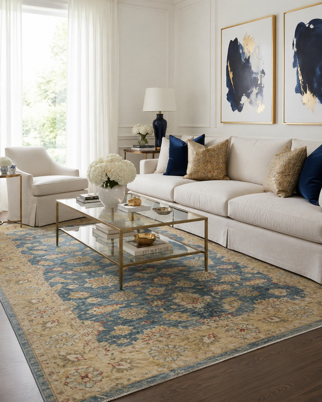 Violet Agra Blue and Gold Hand Knotted Wool area rug styled in an elegant airy living room with white sofa and brass accents - lifestyle photo