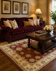 Timeless Oushak Red Hand Knotted Wool area rug styled in a warm traditional living room with burgundy velvet sofa and botanical prints - lifestyle photo