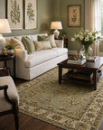 Zinnia Agra Green Hand Knotted Wool Rug in an elegant nature-inspired living room with sage green walls, white linen sofa, and botanical artwork - lifestyle photo