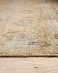 Captivating Traditional Beige Hand Knotted Wool Rug, beige and wool floor covering featuring intricate traditional patterns, lying flat, viewed in a room setting.