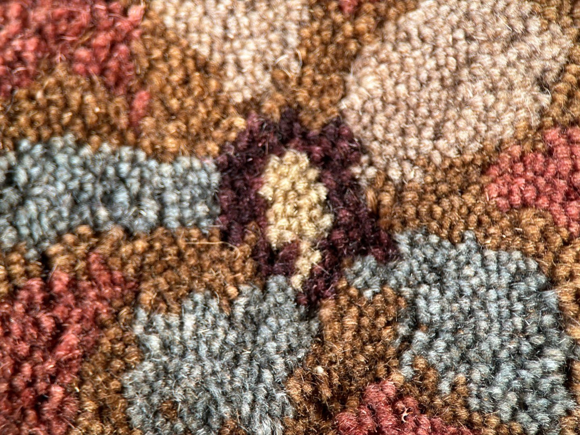 Lydia Vibrant Red Hand Tufted Wool Rug, its fiery red tones and hand-tufted texture radiating warmth in a well-lit living space with modern furniture.