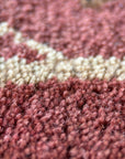 Lydia Vibrant Red Hand Tufted Wool Rug displayed within a bright, modern living room setting. Its bold, vibrant red wool fibers create a striking focal point against neutral furniture. Hand-tufted construction evident in the rug's plush texture.