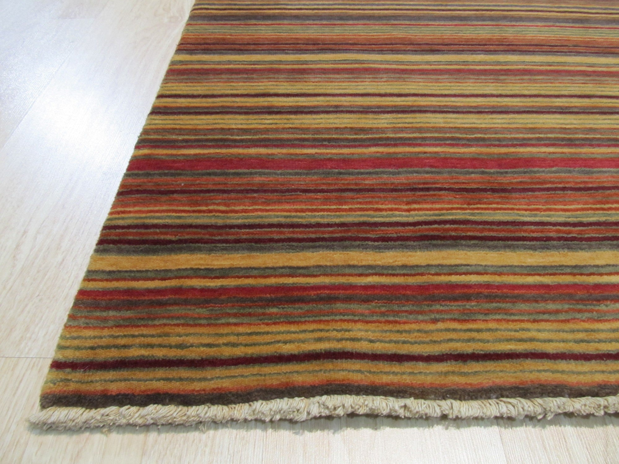 Lush Striped Red Flatweave Wool Rug, warm reds and subtle neutrals create bold stripes in this flatweave wool rug, adding a touch of cozy texture to a modern space.