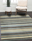 Lila Fiona Multicolor Handmade Wool Rug displayed in a well-lit living room setting, showcasing its vibrant color palette and textured wool construction amidst neutral furniture and warm lighting.