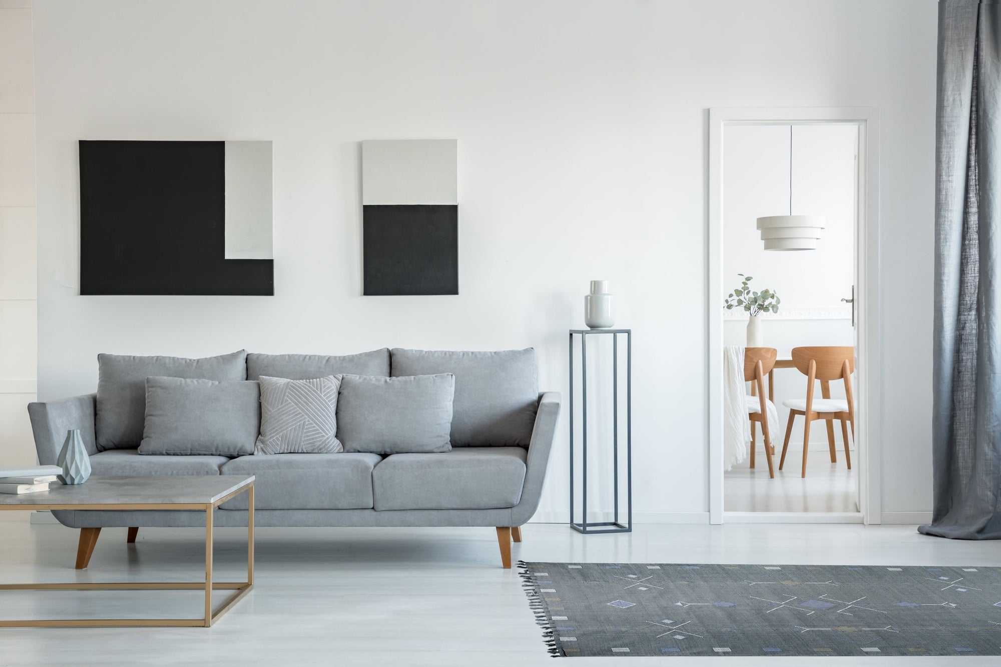 Sleek Inviting Gray Flatweave Rug rests comfortably in a bright living room setting; its flatweave construction adds a touch of understated elegance to the modern space.