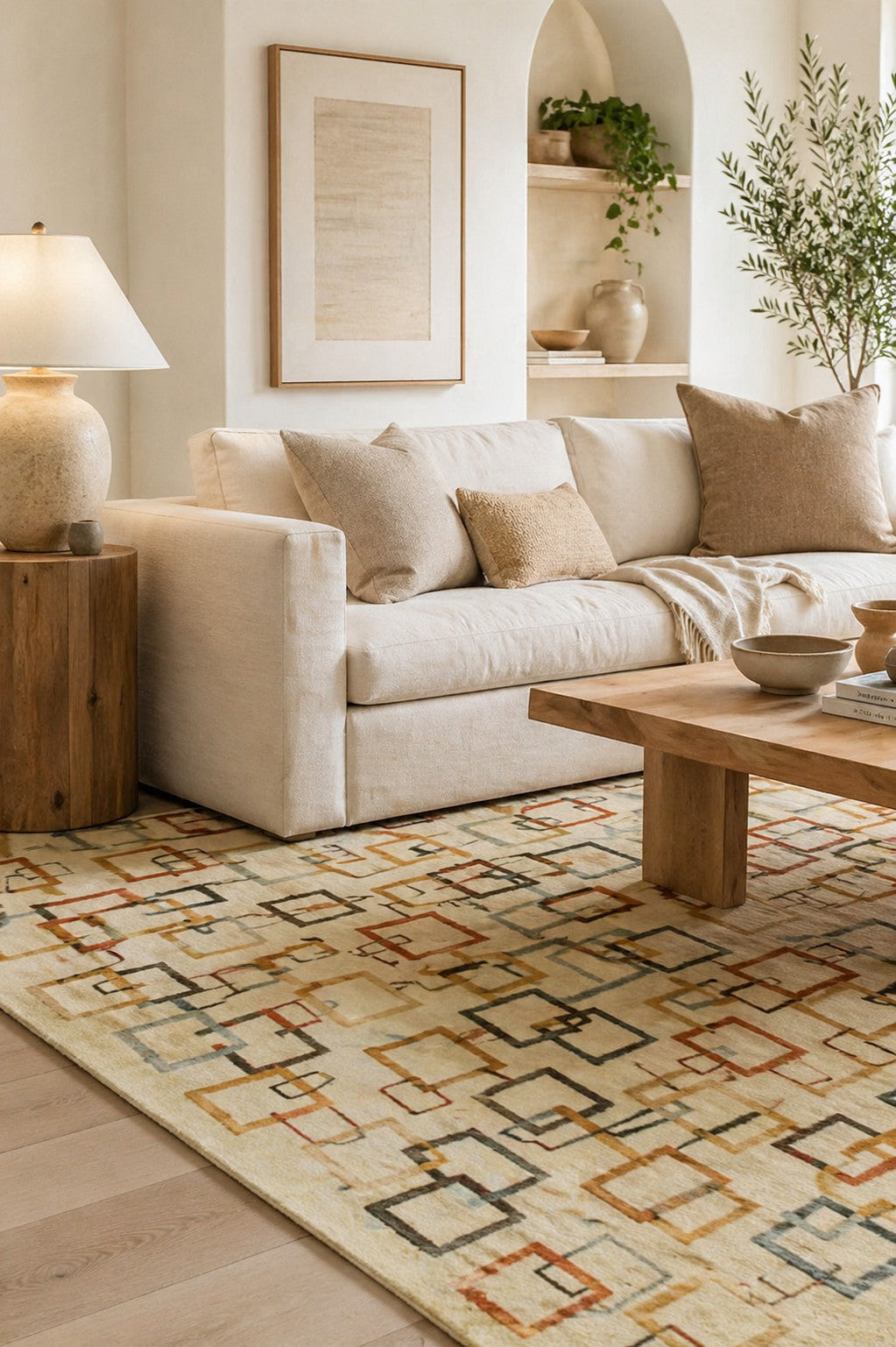 Sandstone Serenity Beige Handmade Wool Ningxia Rug styled in a serene airy living room with cream linen sofa and natural wood accents - area rug lifestyle photo