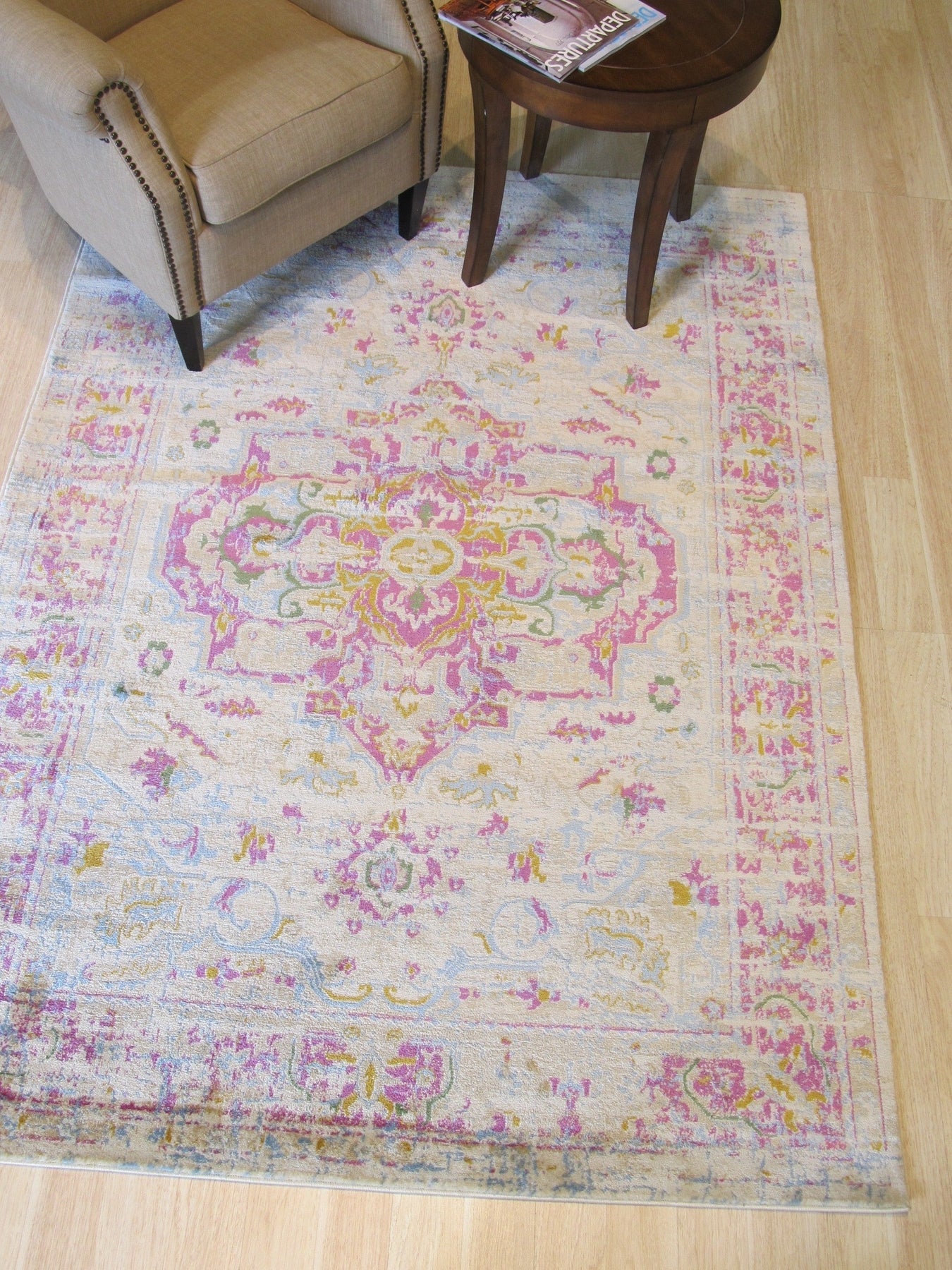 Vibrant Exquisite Ivory Machine Made Rug, displaying a geometric pattern in ivory tones, covers a light wood floor; natural light illuminates the rug&#39;s soft texture and intricate details.