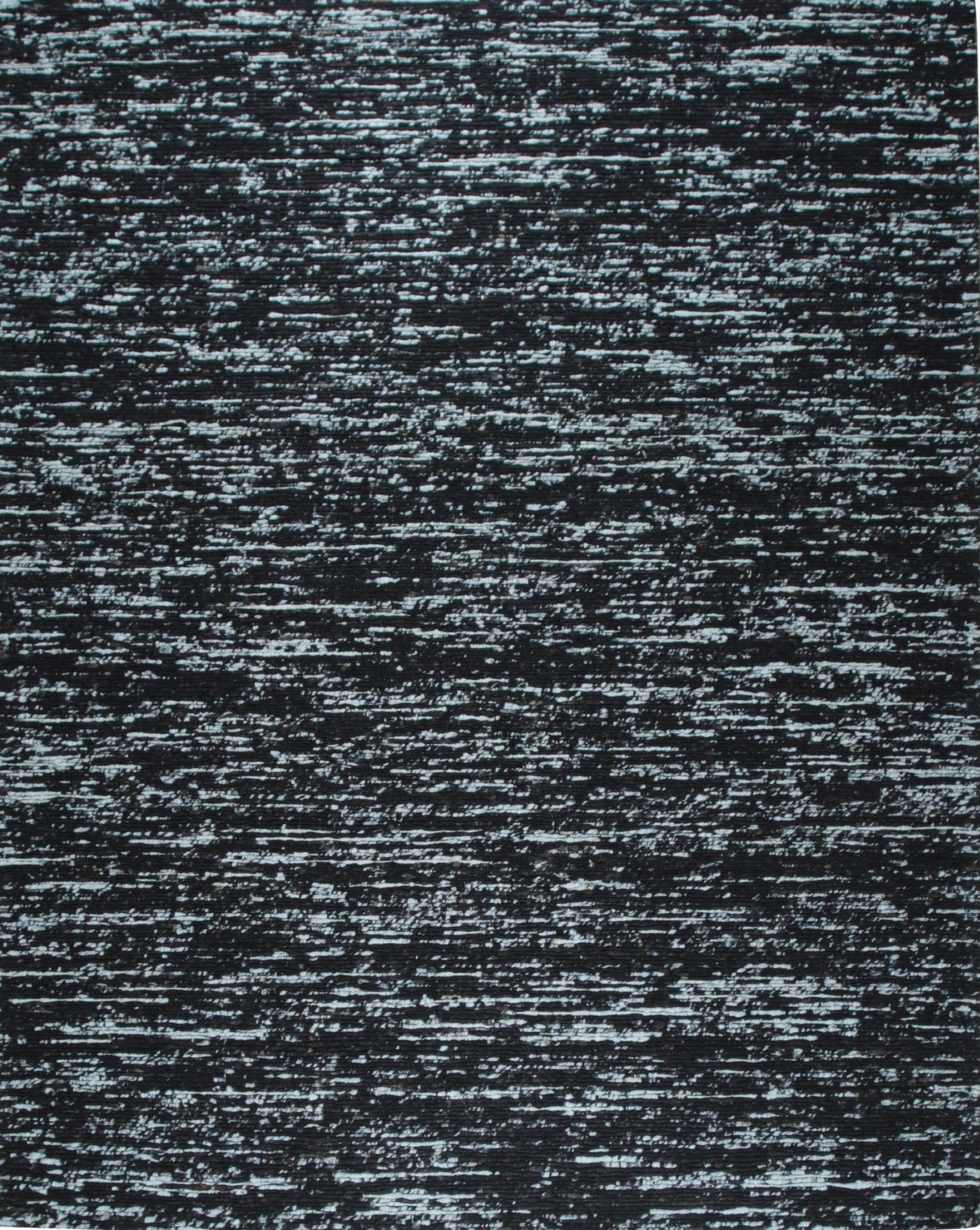 Fiona Rustic Black Flatweave Wool Rug styled in a modern living room - area rug lifestyle photo