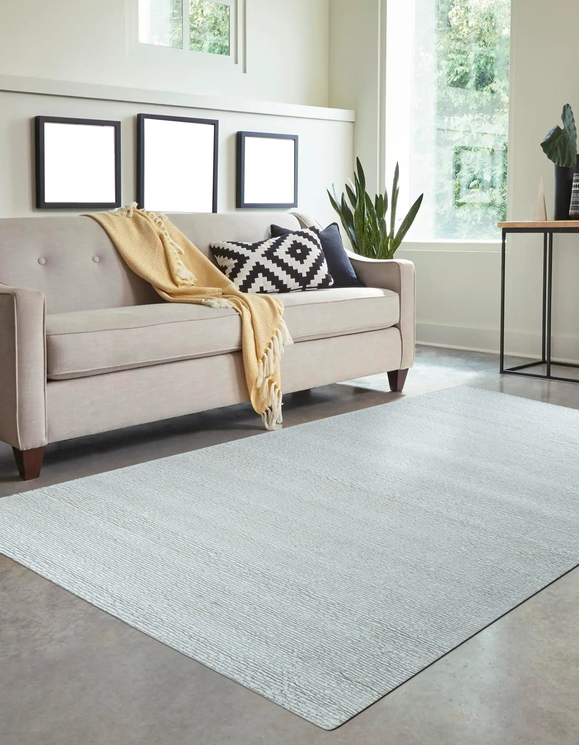 Fiona Rustic Ivory Flatweave Wool Rug, ivory-toned wool rug with subtle texture, lies horizontally on a polished wood floor, showcasing its light, neutral tones and flatweave construction.