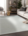 Trara Vibrant White Hand Knotted Wool Rug, its lush pile softly illuminated in natural light, lending warmth and texture to a neutral living space.