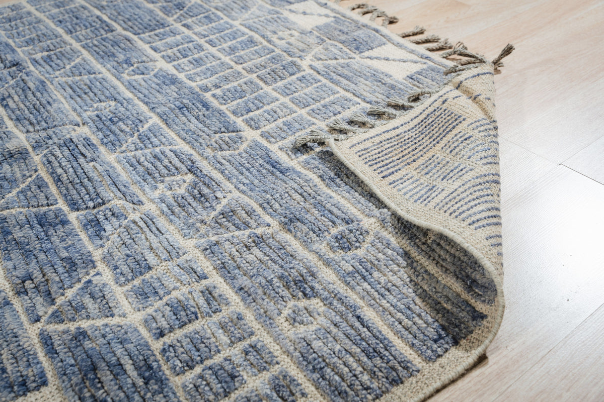 Elegant Marrakech Blue Hand-Knotted Wool Rug, deep blue hues and intricate patterns dance across hand-knotted wool, enriching a living space.