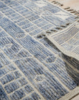 Elegant Marrakech Blue Hand-Knotted Wool Rug, deep blue hues and intricate patterns dance across hand-knotted wool, enriching a living space.