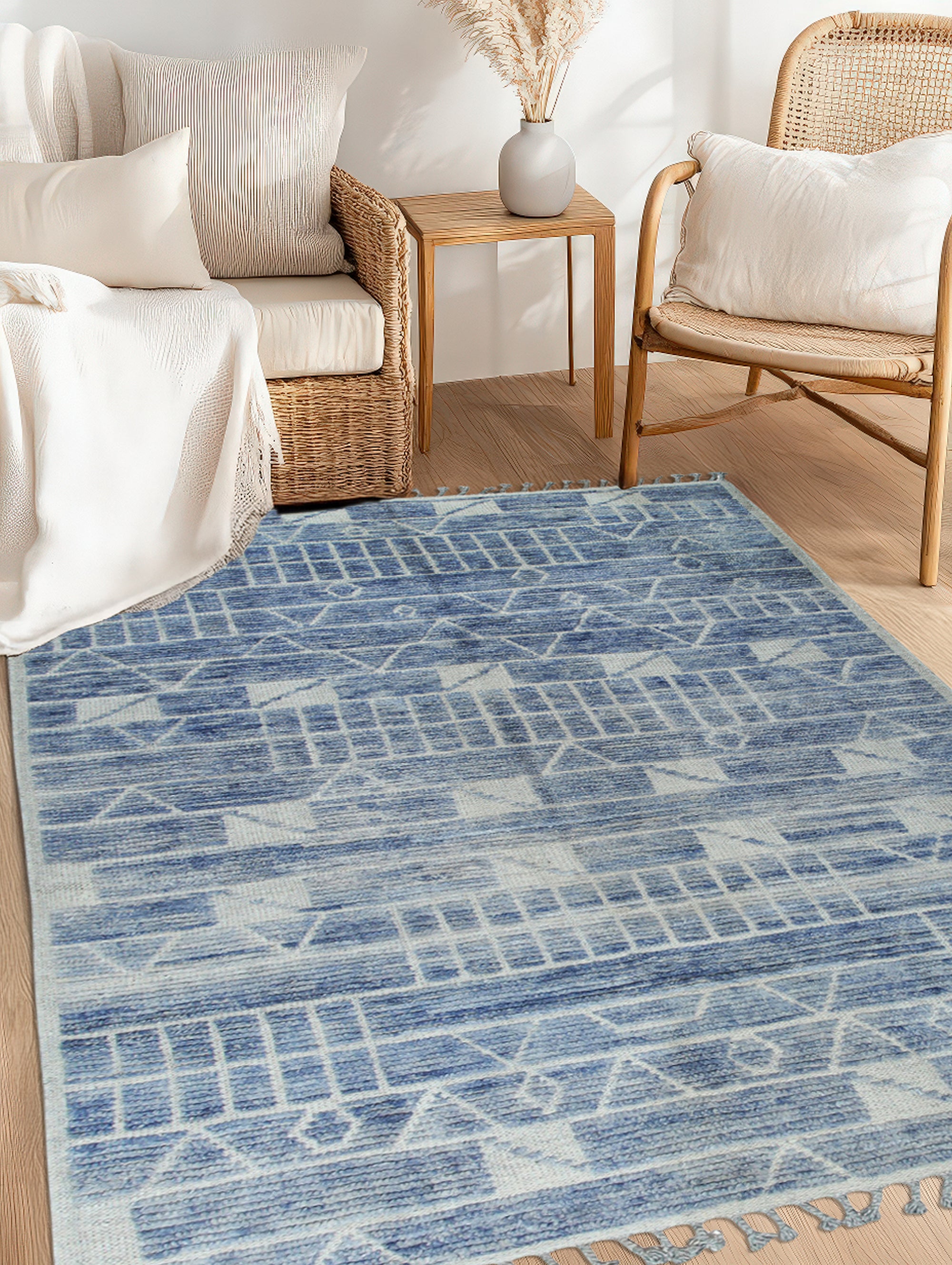 Elegant Marrakech Blue Hand-Knotted Wool Rug, its intricate geometric design in shades of blue and cream pops against a light wooden floor, showcasing the rug's texture and handmade craftsmanship.