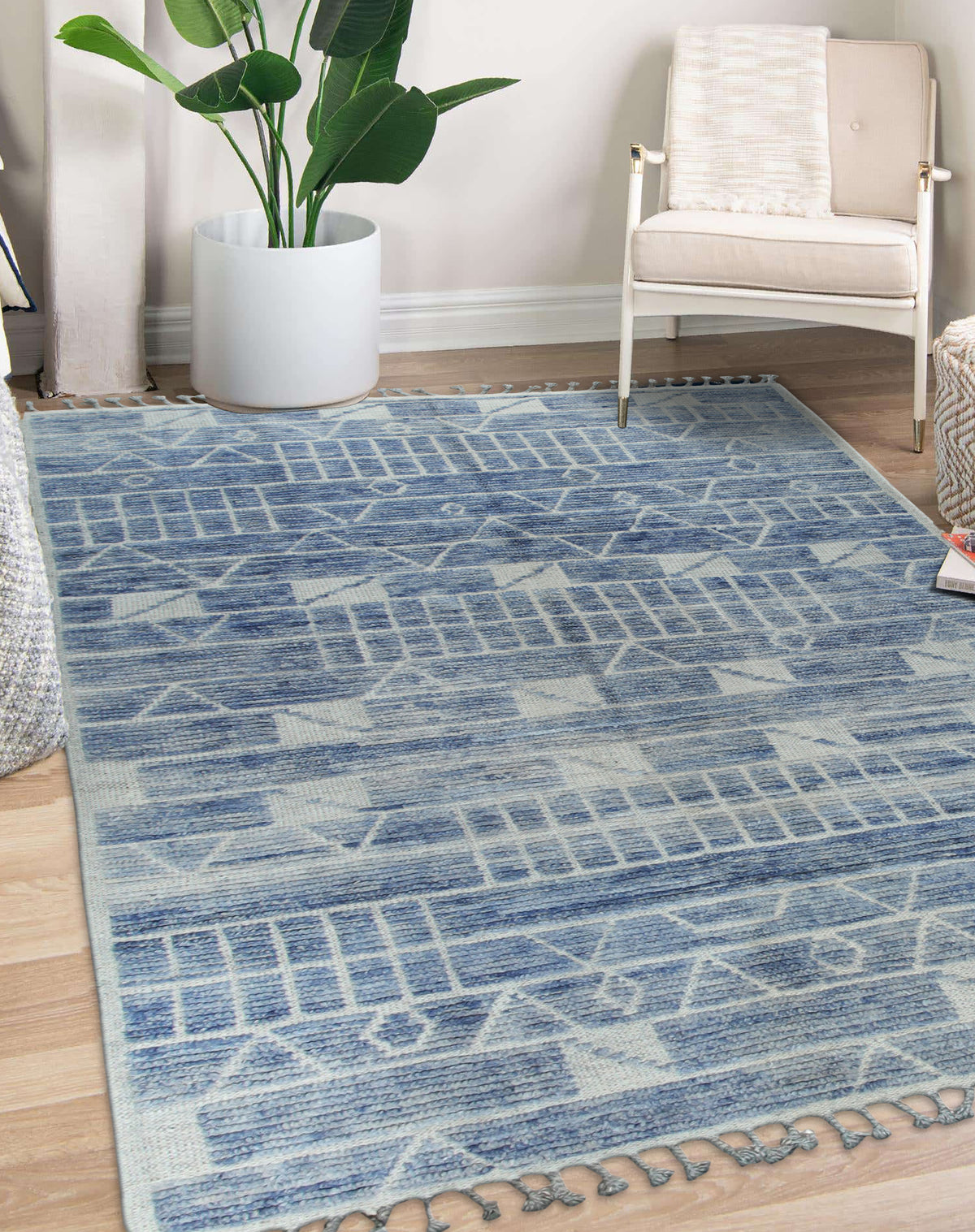 Elegant Marrakech Blue Hand-Knotted Wool Rug, showcasing a deep blue field with intricate geometric patterns, grounding a modern living room with light wood floors and a neutral sofa.