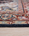 Ella Oriental Navy Hand Knotted Wool Rug, a navy and ivory wool rug with an intricate floral and geometric design, seen in a bright living room setting with a mid-century modern aesthetic.