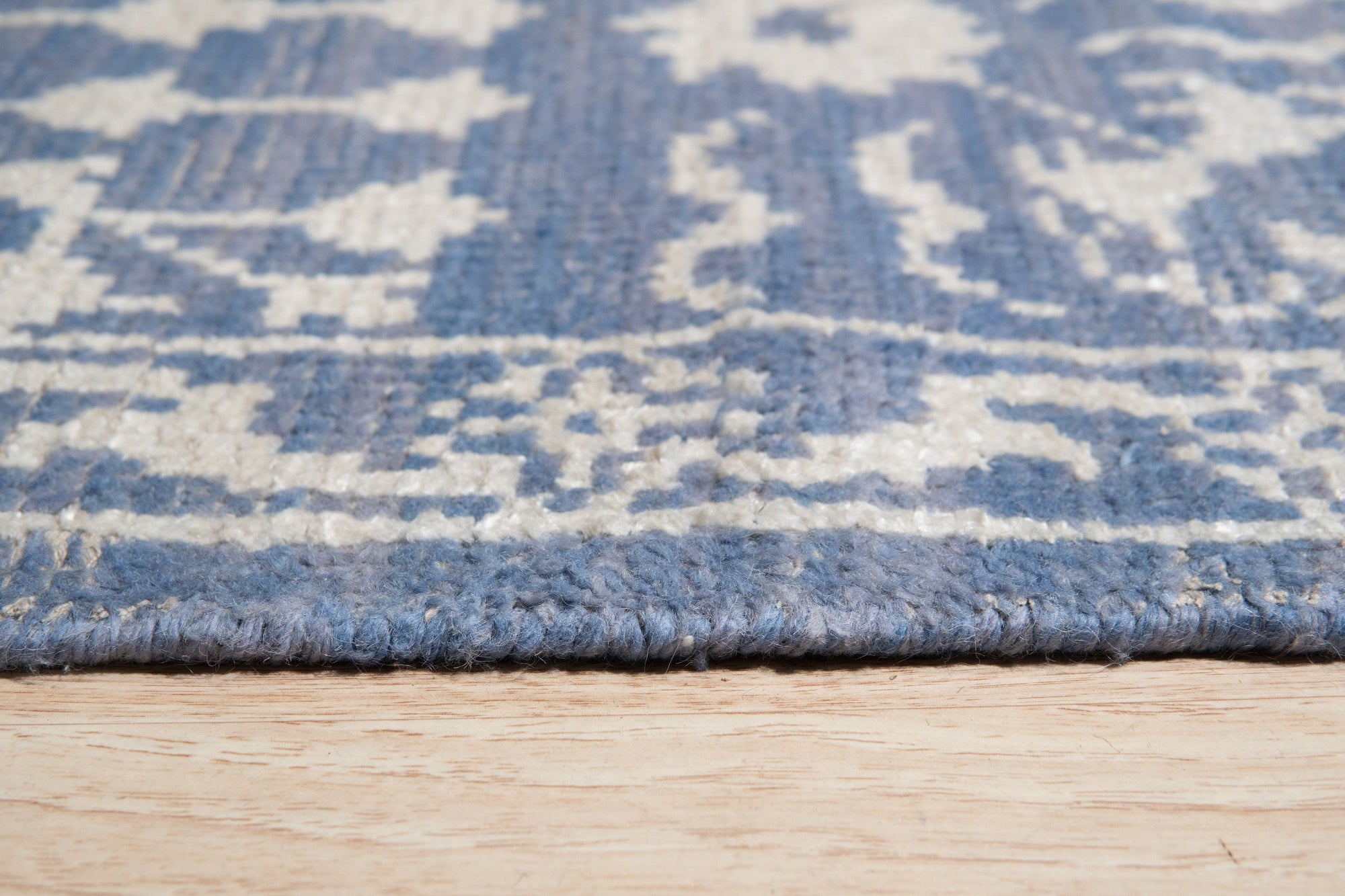 Ava Agra Blue Hand Knotted Wool &amp; Bamboo Silk Rug, its intricate pattern unfolding in serene blues, woven from wool and shimmering bamboo silk, grounding a contemporary living space.